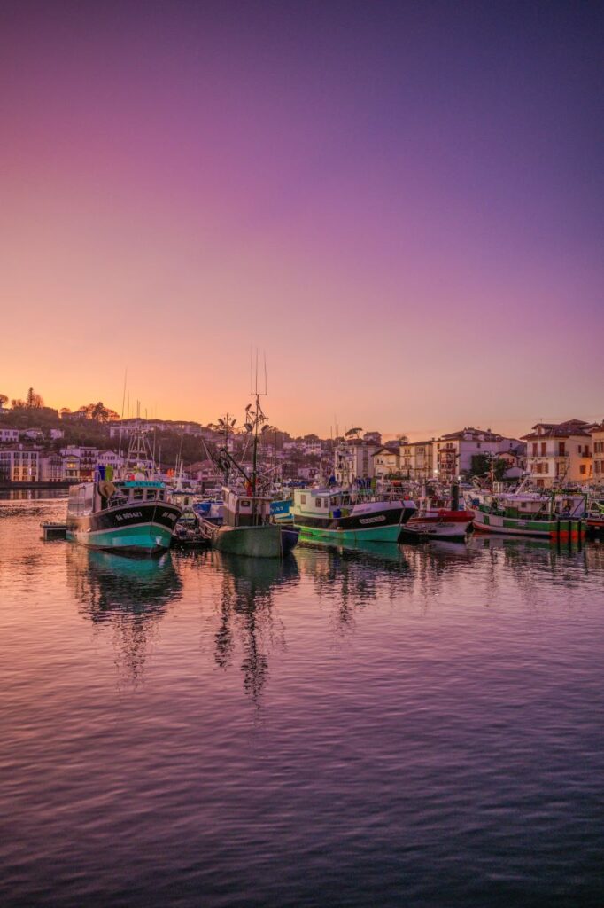 Boats in water during sunset