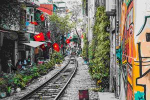 train tracks surrounded by colorful buildings and red flags
